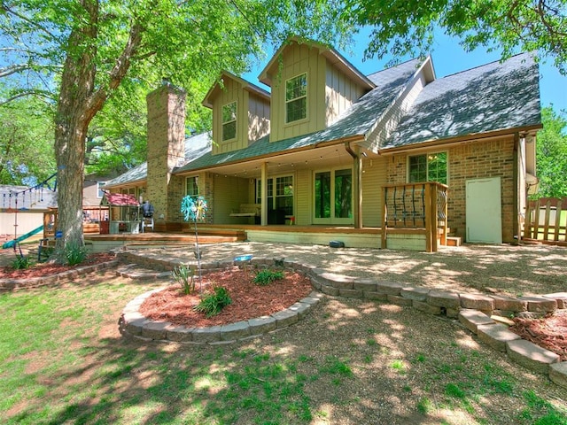 402 Hunters Ct, Edmond, OK 73034 - back of house featuring board and batten siding and a patio
