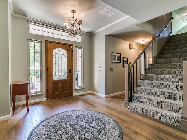 402 Hunters Ct, Edmond, OK 73034 - foyer featuring a chandelier, hardwood / wood-style flooring, stairway, and ornamental molding