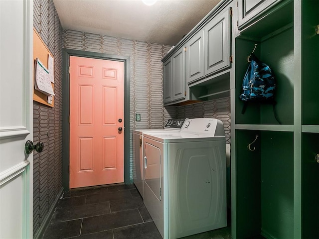 402 Hunters Ct, Edmond, OK 73034 - laundry room with washer and clothes dryer, cabinet space, and wallpapered walls