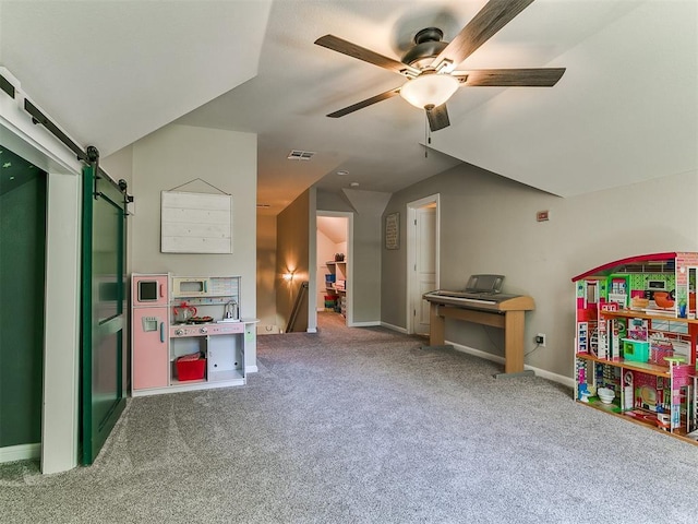 402 Hunters Ct, Edmond, OK 73034 - game room featuring a barn door, ceiling fan, and carpet flooring