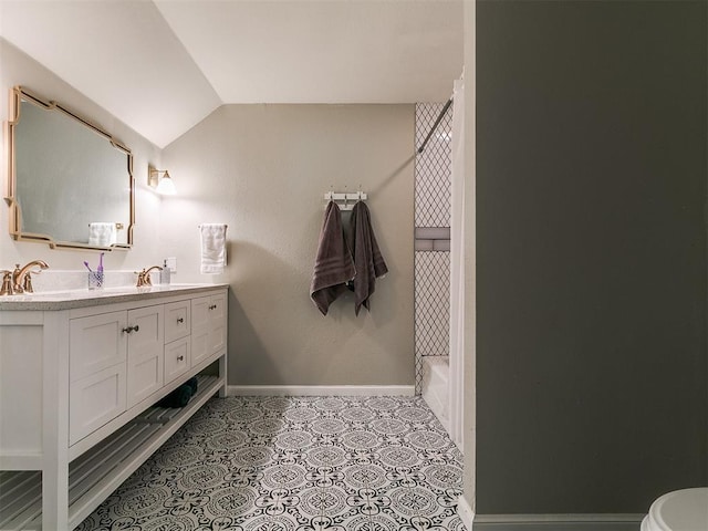402 Hunters Ct, Edmond, OK 73034 - bathroom featuring lofted ceiling, double vanity, and a tub to relax in