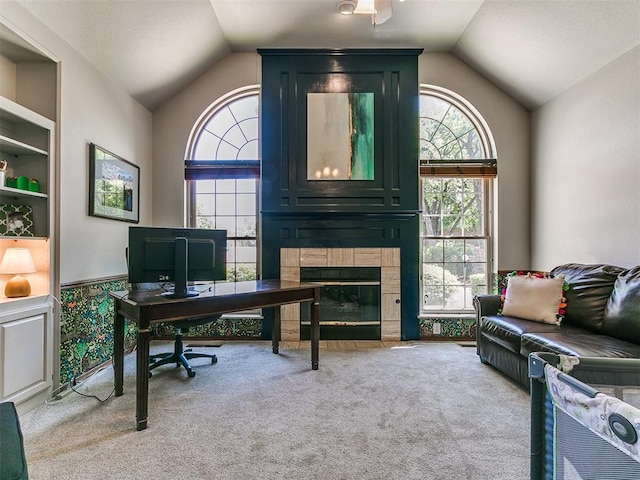 402 Hunters Ct, Edmond, OK 73034 - home office featuring lofted ceiling, carpet flooring, and a tiled fireplace