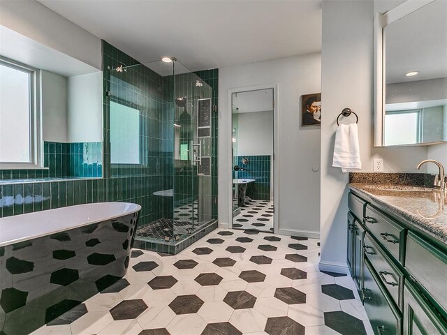 402 Hunters Ct, Edmond, OK 73034 - bathroom featuring a freestanding bath, a stall shower, vanity, and tile patterned floors