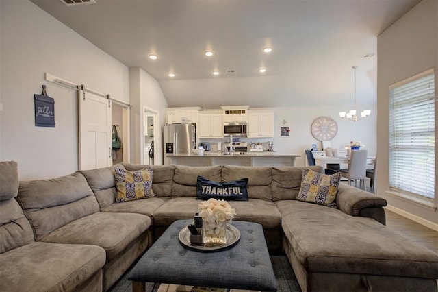 4004 Brougham Way, Oklahoma City, OK 73179 - living area featuring a chandelier, a barn door, vaulted ceiling, recessed lighting, and wood finished floors