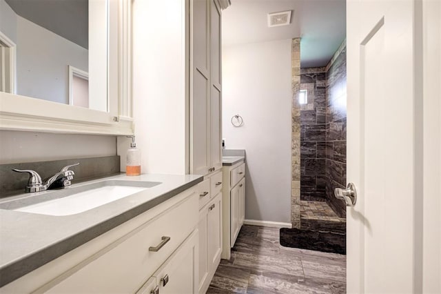 4004 Brougham Way, Oklahoma City, OK 73179 - bathroom with vanity, walk in shower, and wood finished floors