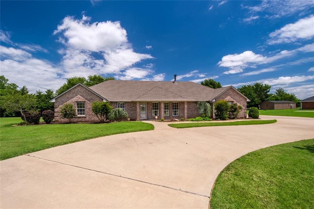 1617 SE 5th St, Newcastle, OK 73065 - single story home with brick siding, curved driveway, and a front lawn