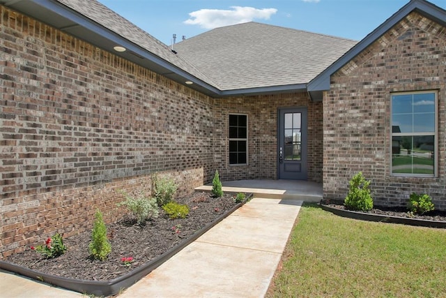 4204 Chesterfield Pl, Oklahoma City, OK 73179 - entrance to property featuring brick siding, a shingled roof, and a lawn