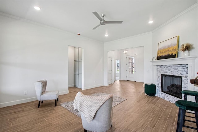 4204 Chesterfield Pl, Oklahoma City, OK 73179 - sitting room featuring wood finished floors, ceiling fan, crown molding, a stone fireplace, and recessed lighting
