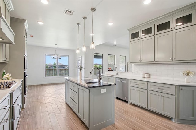 4204 Chesterfield Pl, Oklahoma City, OK 73179 - kitchen with stainless steel appliances, gray cabinetry, light wood finished floors, backsplash, and recessed lighting