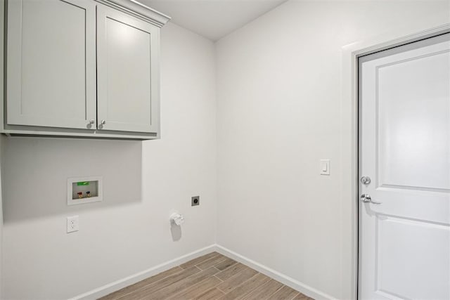 4204 Chesterfield Pl, Oklahoma City, OK 73179 - washroom with hookup for an electric dryer, light wood-style flooring, washer hookup, and cabinet space