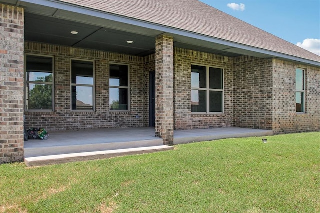 4204 Chesterfield Pl, Oklahoma City, OK 73179 - back of house with a lawn, roof with shingles, and brick siding