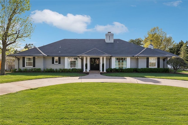 view of front of home featuring a front lawn and a chimney