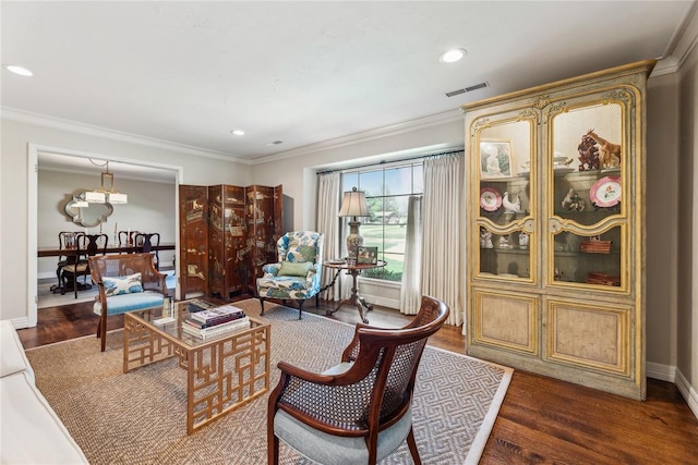 living room with wood finished floors, ornamental molding, and recessed lighting