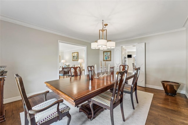 dining room featuring wood finished floors, ornamental molding, and a chandelier
