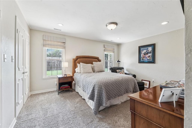 bedroom featuring light carpet and recessed lighting