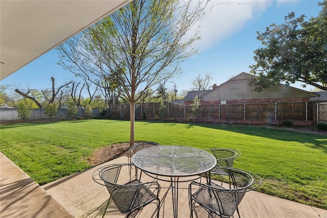 fenced backyard featuring a patio and outdoor dining space