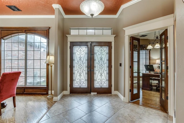 405 Kingsgate Rd, Yukon, OK 73099 - entrance foyer with french doors, healthy amount of natural light, ornamental molding, and wood finished floors