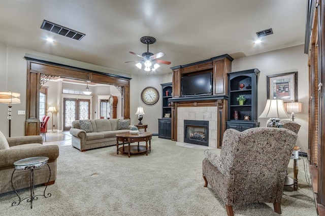 405 Kingsgate Rd, Yukon, OK 73099 - living area featuring a ceiling fan, carpet floors, and a tiled fireplace