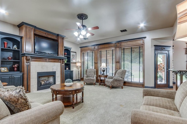 405 Kingsgate Rd, Yukon, OK 73099 - living room with a ceiling fan, a tiled fireplace, and carpet flooring