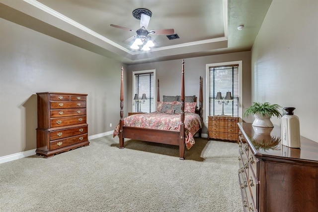 405 Kingsgate Rd, Yukon, OK 73099 - bedroom featuring a raised ceiling, multiple windows, light carpet, crown molding, and ceiling fan