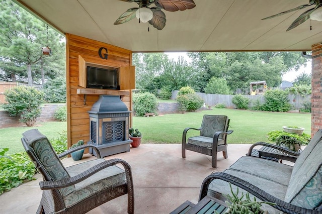 405 Kingsgate Rd, Yukon, OK 73099 - fenced backyard with exterior fireplace, ceiling fan, and a patio