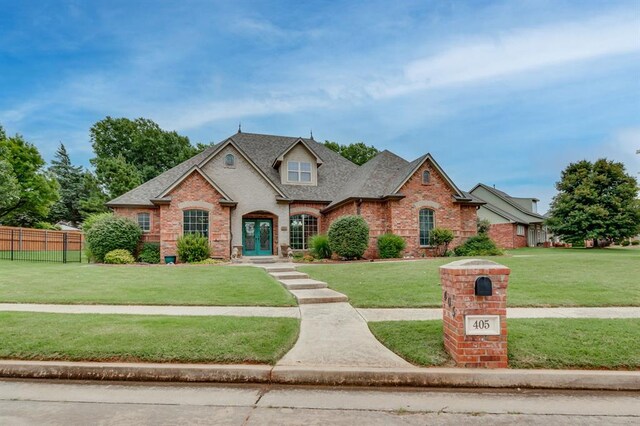 405 Kingsgate Rd, Yukon, OK 73099 - traditional home with brick siding, roof with shingles, and french doors