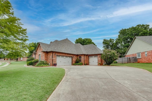 405 Kingsgate Rd, Yukon, OK 73099 - view of front facade with an attached garage, concrete driveway, brick siding, and roof with shingles