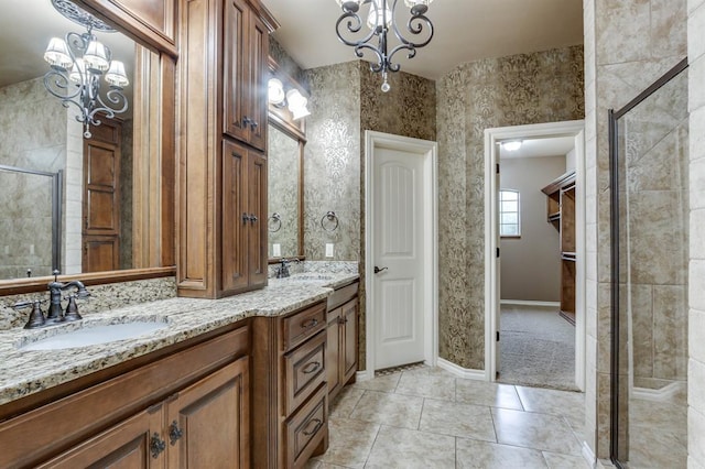 405 Kingsgate Rd, Yukon, OK 73099 - bathroom with a chandelier, double vanity, a shower stall, and tile patterned floors