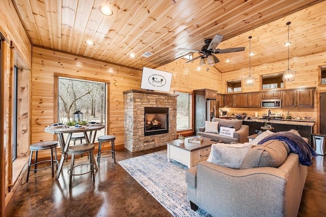 944 Camp Ranch Rd, Broken Bow, OK 74728 - living area with concrete flooring, recessed lighting, a ceiling fan, a fireplace, and lofted ceiling