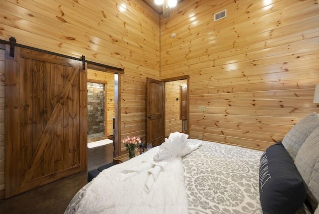 944 Camp Ranch Rd, Broken Bow, OK 74728 - bedroom featuring a barn door and wooden walls