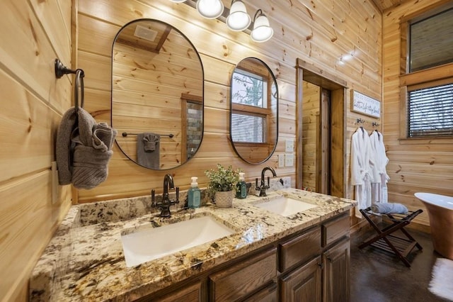 944 Camp Ranch Rd, Broken Bow, OK 74728 - bathroom featuring wood walls, double vanity, healthy amount of natural light, and a freestanding bath
