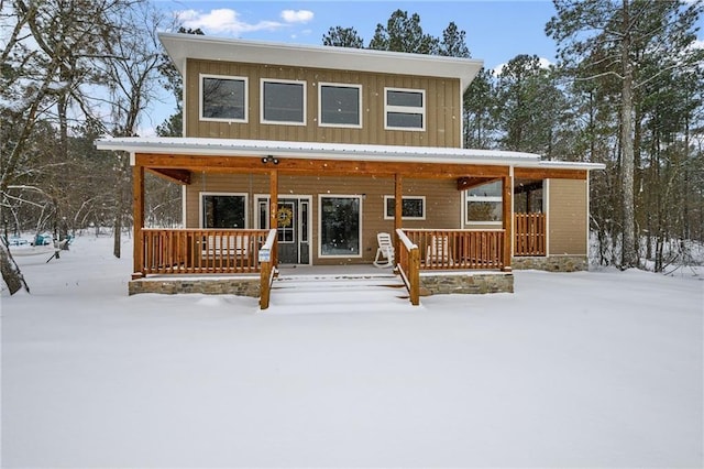 944 Camp Ranch Rd, Broken Bow, OK 74728 - snow covered back of property with covered porch