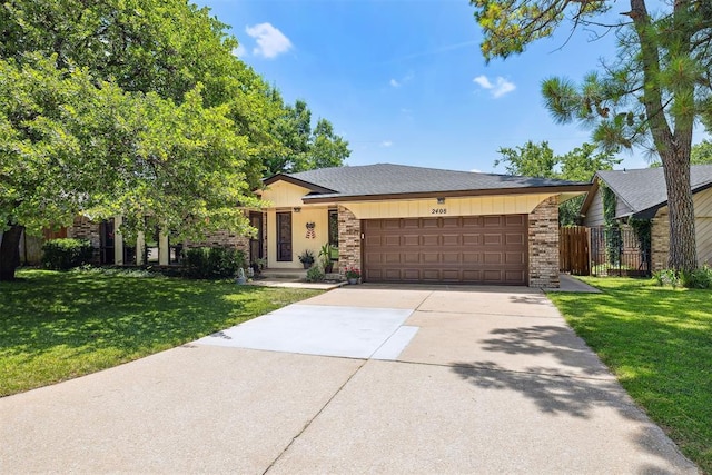 2408 Shady Tree Ln, Edmond, OK 73013 - view of front facade featuring a garage, concrete driveway, brick siding, and a shingled roof