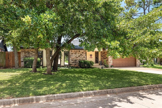 2408 Shady Tree Ln, Edmond, OK 73013 - view of property hidden behind natural elements with driveway, brick siding, and an attached garage