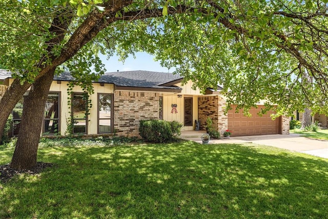 2408 Shady Tree Ln, Edmond, OK 73013 - view of front of home with driveway, a front yard, an attached garage, roof with shingles, and brick siding
