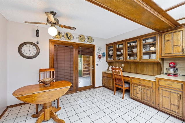 2408 Shady Tree Ln, Edmond, OK 73013 - office featuring built in desk, a ceiling fan, and light tile patterned flooring
