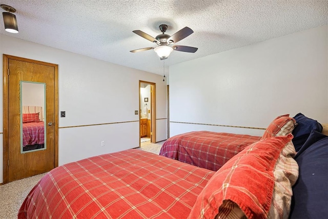 2408 Shady Tree Ln, Edmond, OK 73013 - carpeted bedroom featuring a ceiling fan and a textured ceiling