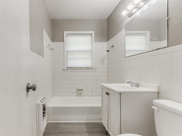 3320 NE 14th St, Oklahoma City, OK 73117 - full bathroom with tile walls, vanity, bathing tub / shower combination, wood finished floors, and heating unit