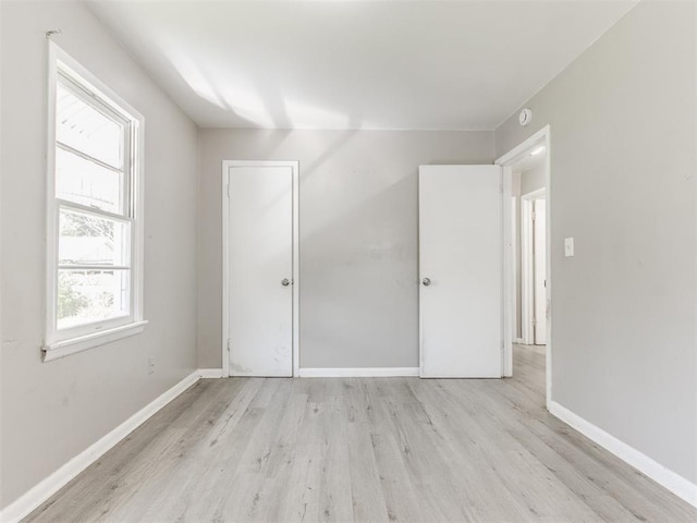 3320 NE 14th St, Oklahoma City, OK 73117 - unfurnished bedroom with wood finished floors and baseboards