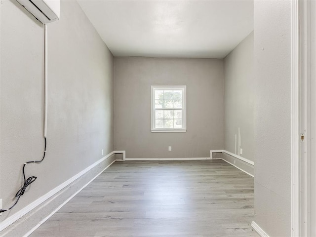 3320 NE 14th St, Oklahoma City, OK 73117 - spare room with wood finished floors and a wall mounted air conditioner