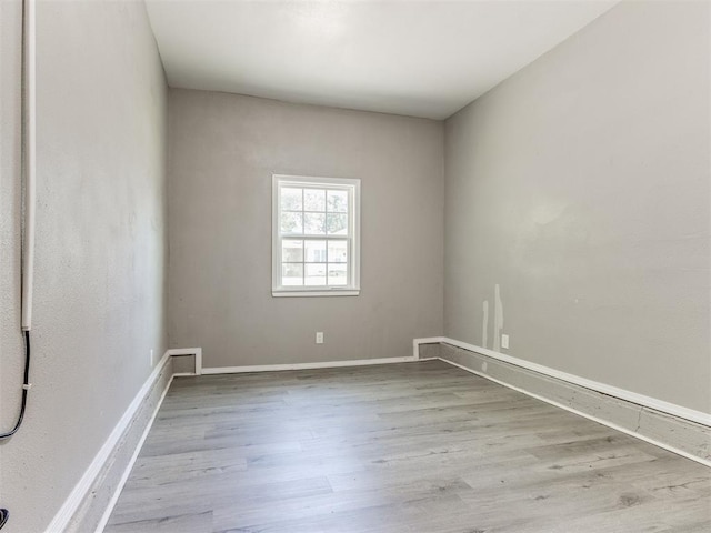 3320 NE 14th St, Oklahoma City, OK 73117 - spare room with wood finished floors and baseboards