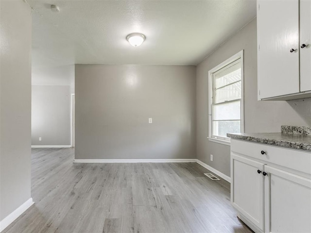 3320 NE 14th St, Oklahoma City, OK 73117 - unfurnished dining area featuring light wood-type flooring and baseboards