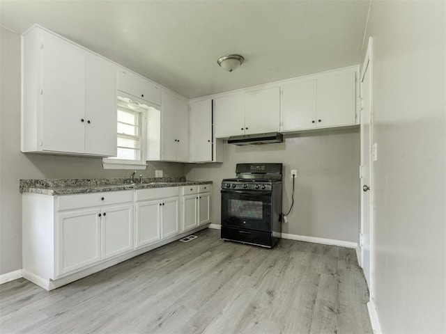 3320 NE 14th St, Oklahoma City, OK 73117 - kitchen featuring black gas range, white cabinets, light wood-style flooring, and under cabinet range hood