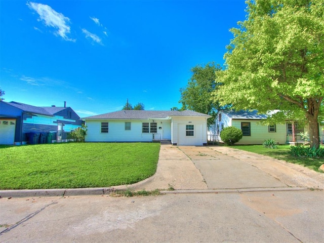 3320 NE 14th St, Oklahoma City, OK 73117 - ranch-style home featuring concrete driveway and a front yard