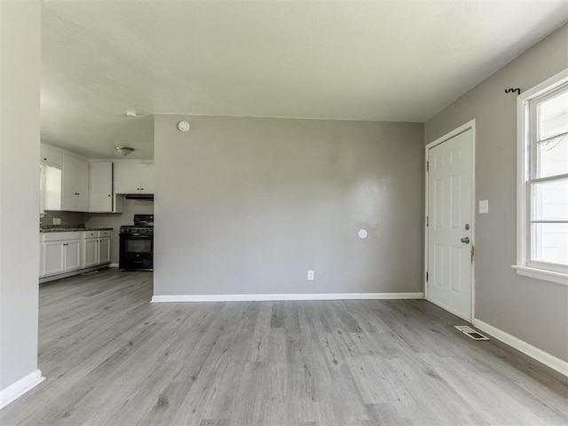 3320 NE 14th St, Oklahoma City, OK 73117 - unfurnished living room featuring light wood finished floors