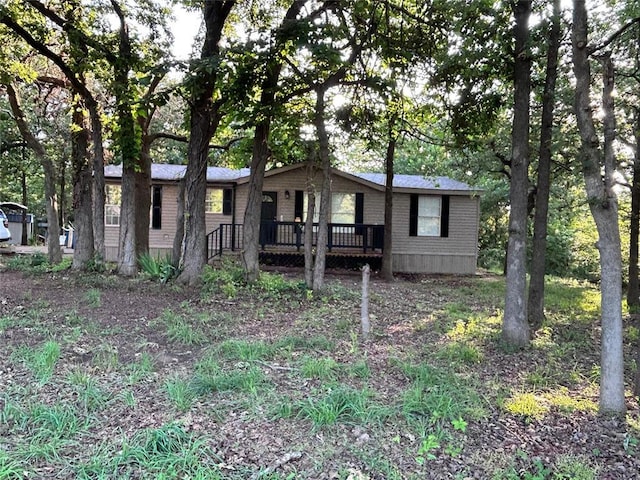 13001 Fox Pass Rd, Edmond, OK 73034 - manufactured / mobile home with brick siding and a wooden deck