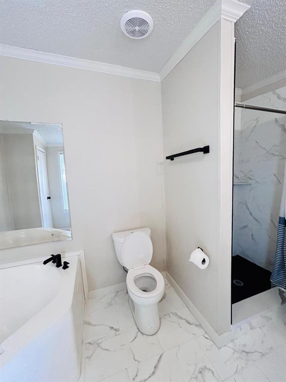 13001 Fox Pass Rd, Edmond, OK 73034 - full bathroom featuring a textured ceiling, a marble finish shower, marble look tile flooring, and ornamental molding