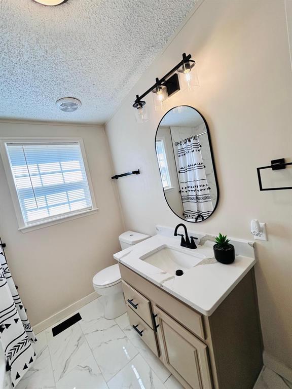 13001 Fox Pass Rd, Edmond, OK 73034 - full bathroom featuring vanity and marble look tile flooring