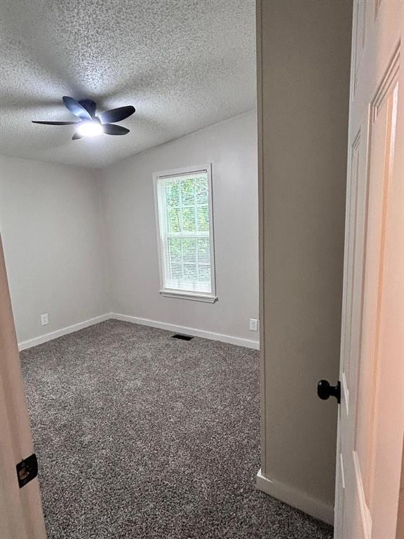 13001 Fox Pass Rd, Edmond, OK 73034 - carpeted spare room featuring a textured ceiling and a ceiling fan
