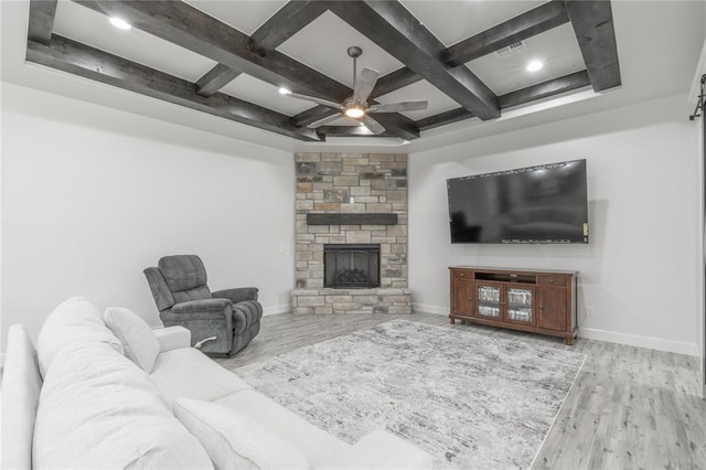 8908 NW 130th St, Oklahoma City, OK 73142 - living area with coffered ceiling, ceiling fan, wood finished floors, beamed ceiling, and a stone fireplace